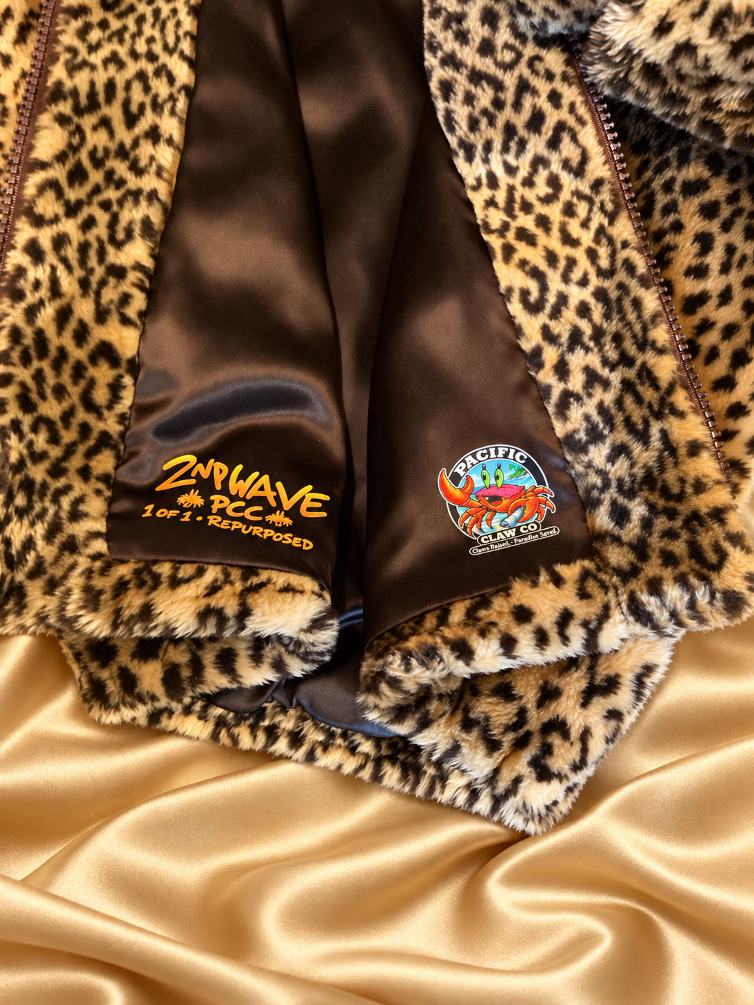 Second Wave and Pacific Claw interior badges on leopard jacket with golden satin background