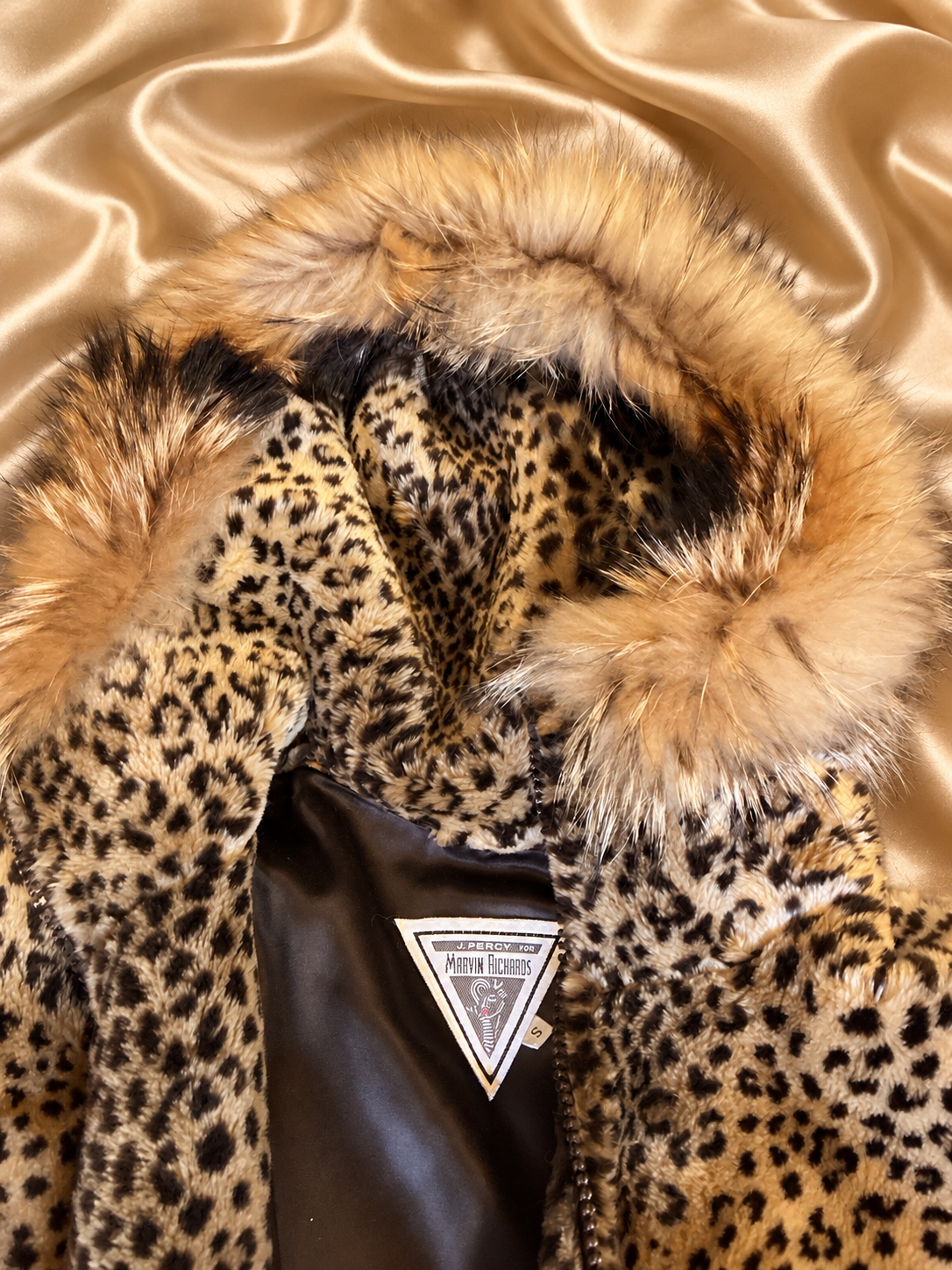 Fur-trimmed hood and neckline of Simply Coastal Fabulous jacket on golden satin