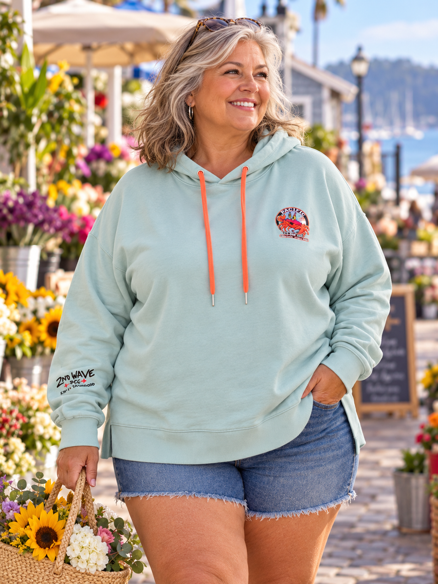 Second Wave Pale Blue Pura Vida Hoodie — Women's 3X — mature model in a relaxed coastal setting