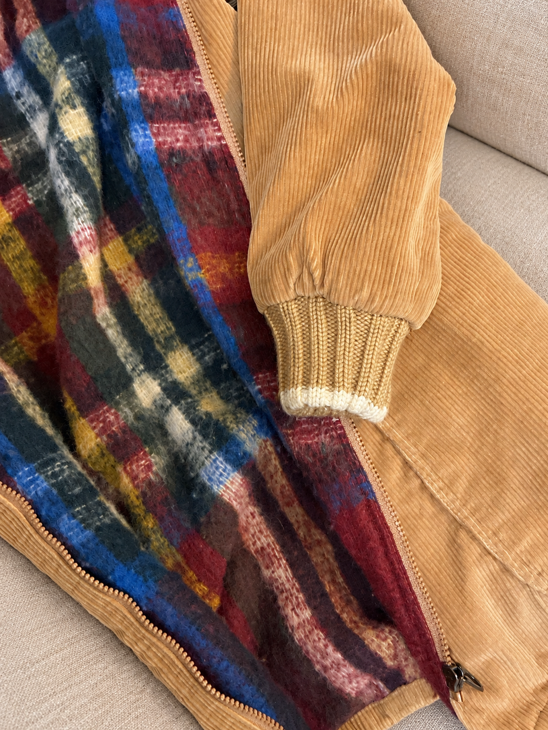 Corduroy coat on a soft beige couch — detail 3
