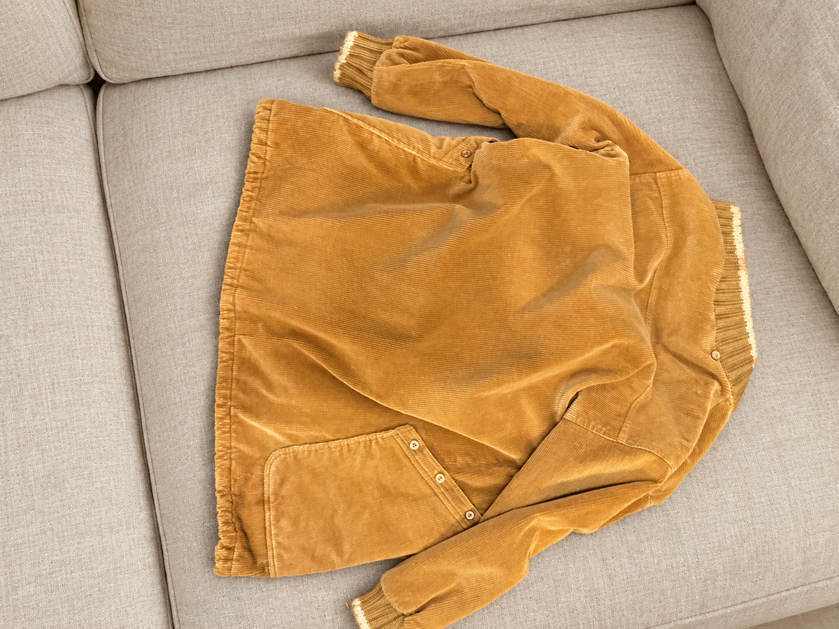 Corduroy coat on a soft beige couch — detail 4