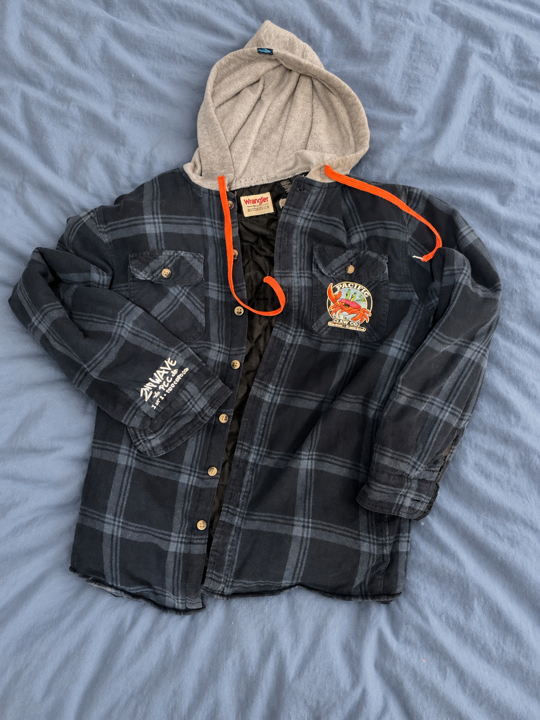 Blue Wrangler jacket on a soft blue bedspread — detail 2