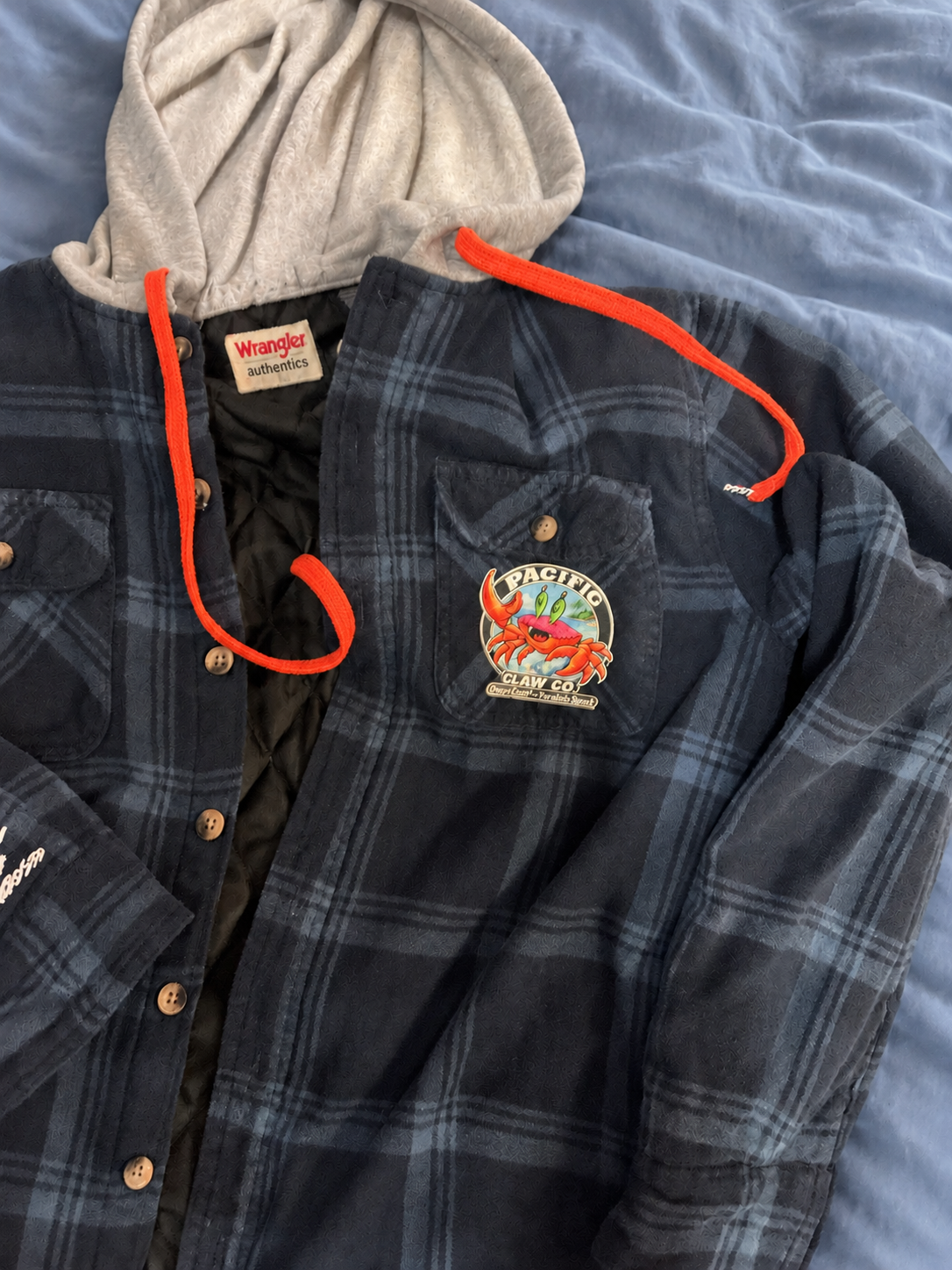 Blue Wrangler jacket on a soft blue bedspread — detail 3