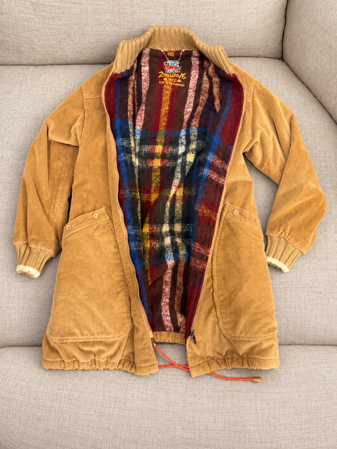 Corduroy coat on a soft beige couch — detail 1