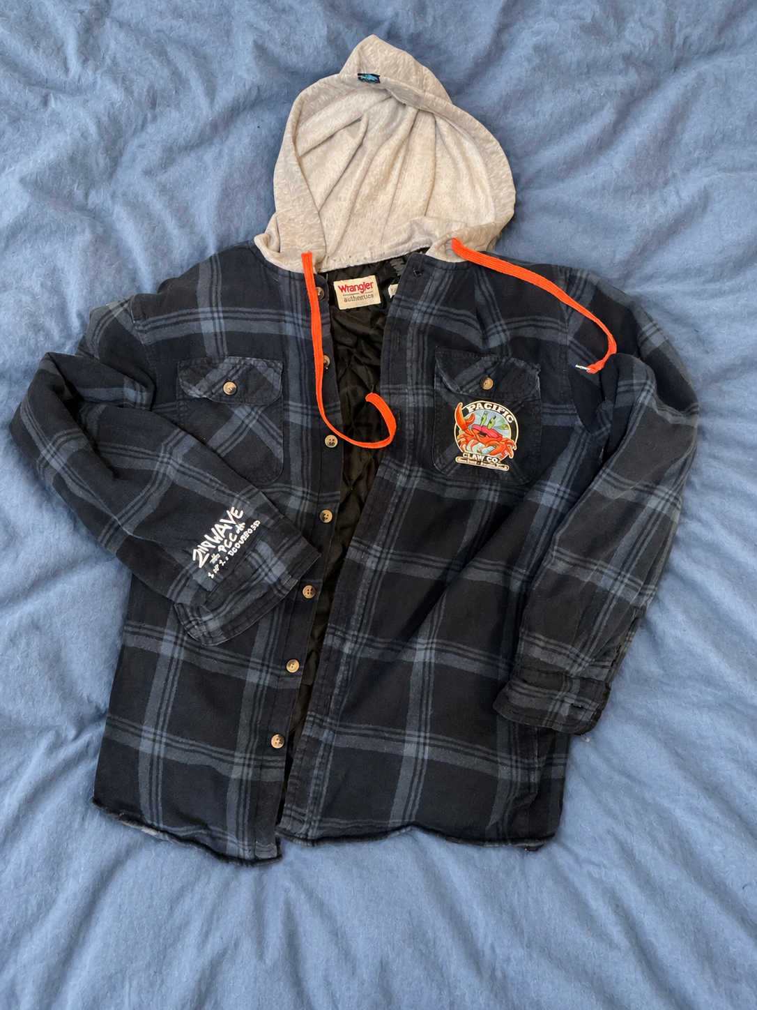 Blue Wrangler jacket on a soft blue bedspread — detail 1