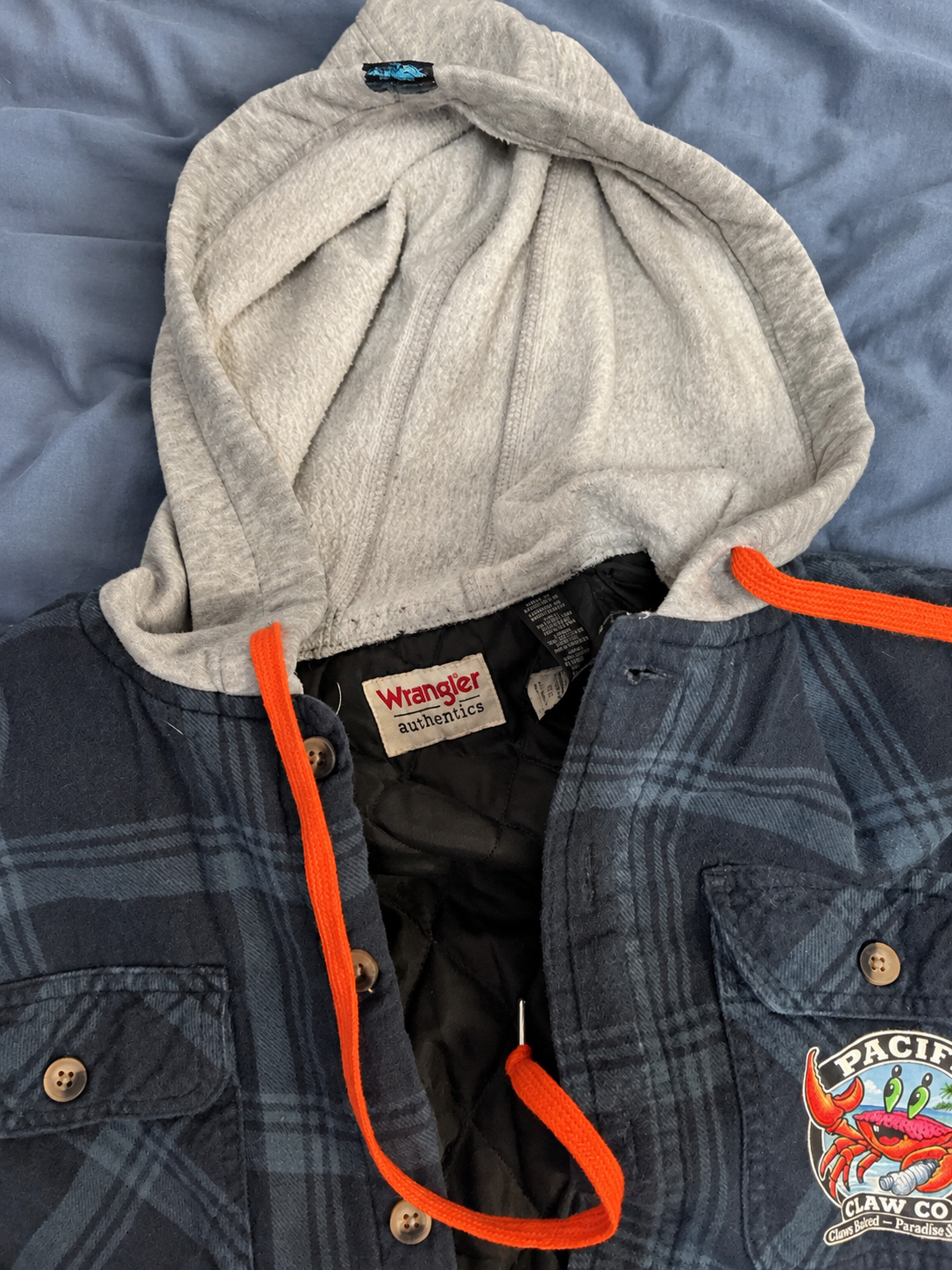 Blue Wrangler jacket on a soft blue bedspread — detail 4